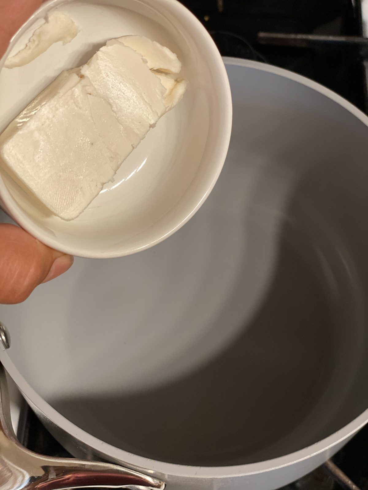 process shot of pouring butter into pan