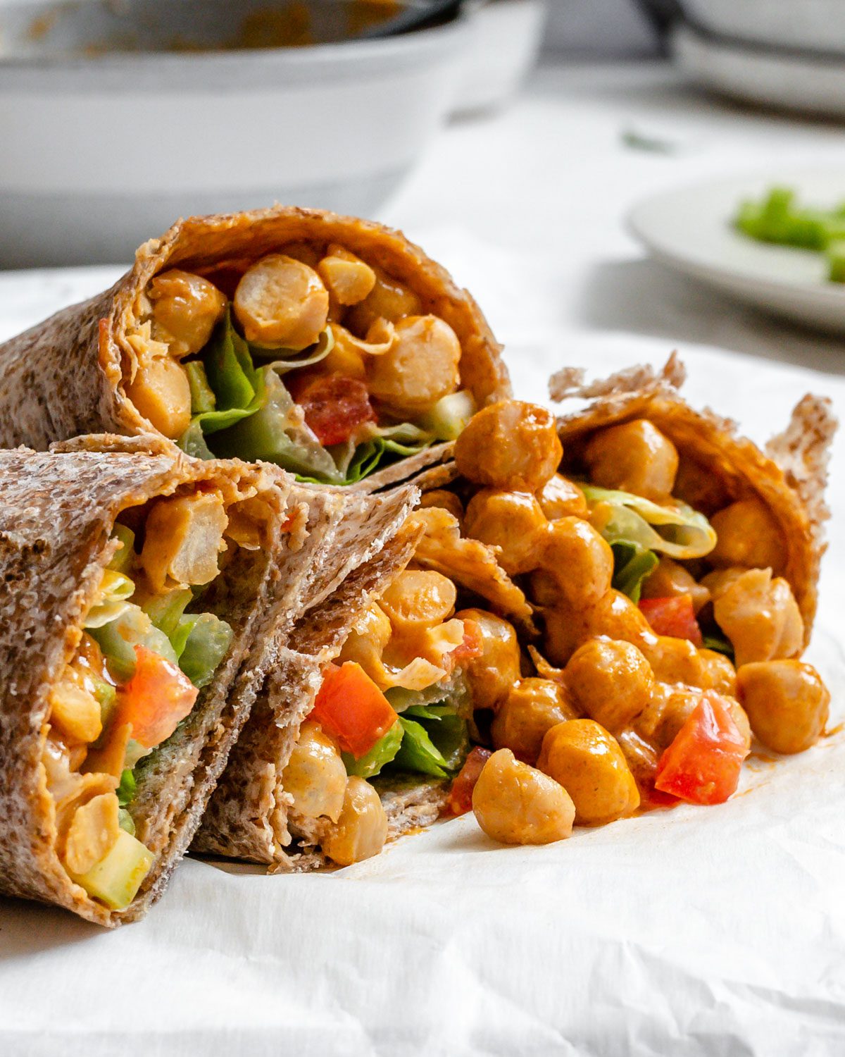 Completed Buffalo Chickpea Wraps on a white surface.