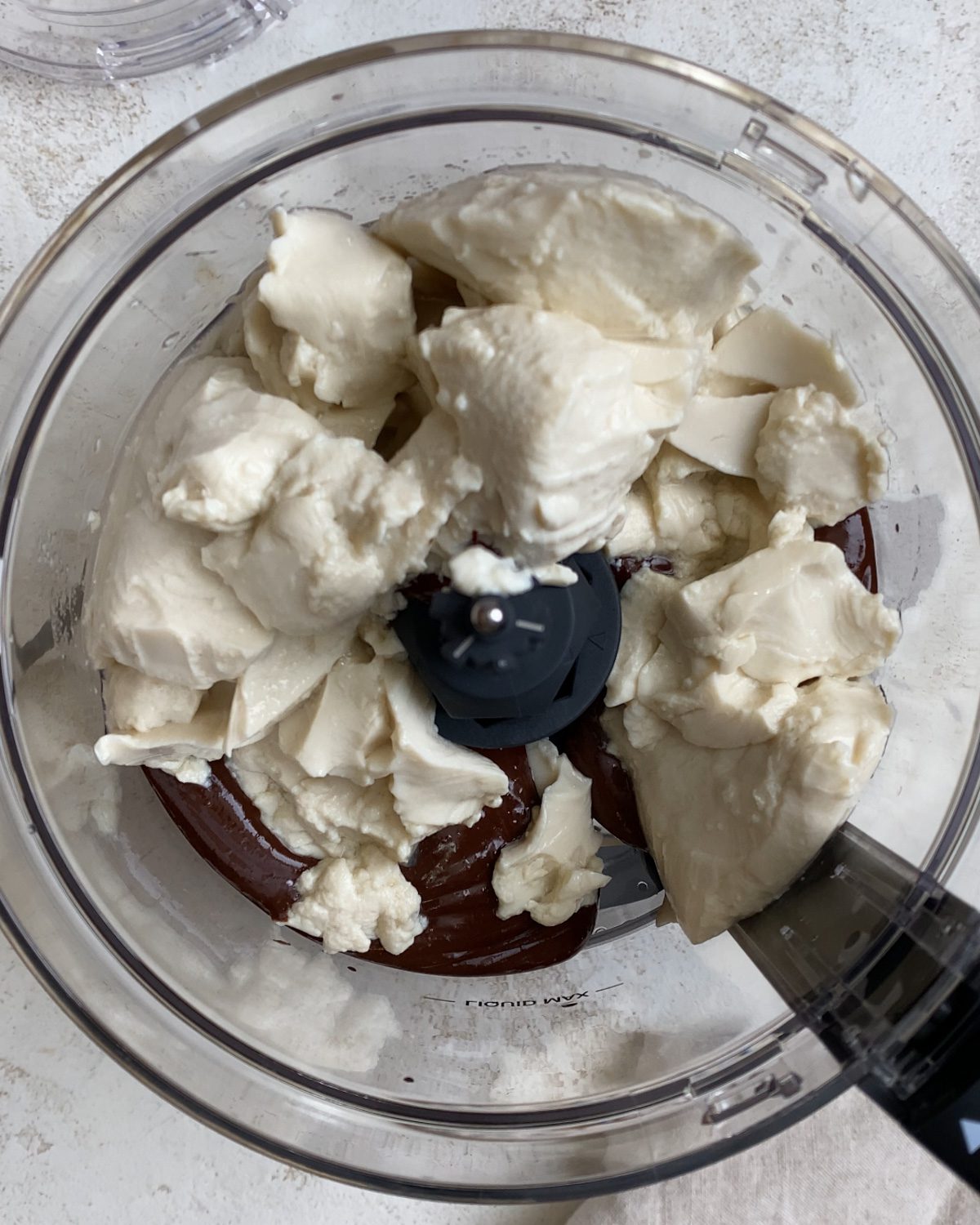 process shot of tofu added to food processor