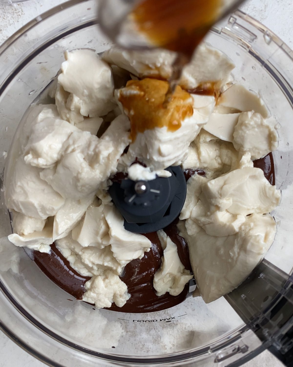 process shot of vanilla added to food processor
