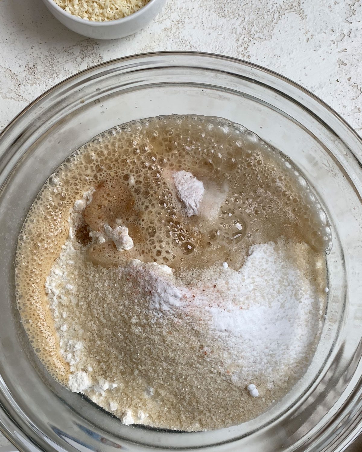 process shot of ingredients mixed together in glass bowl