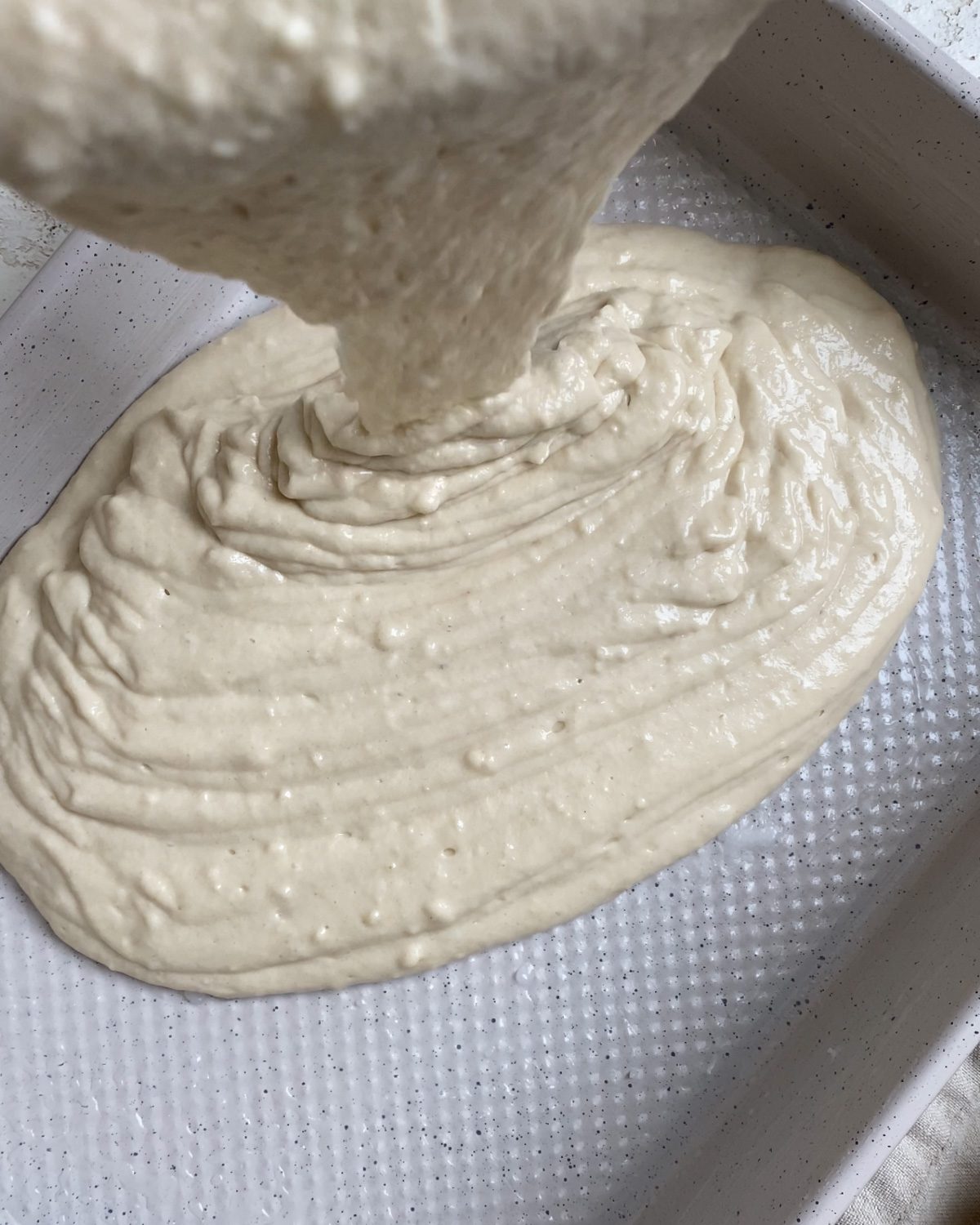 process shot of adding mixture to baking dish