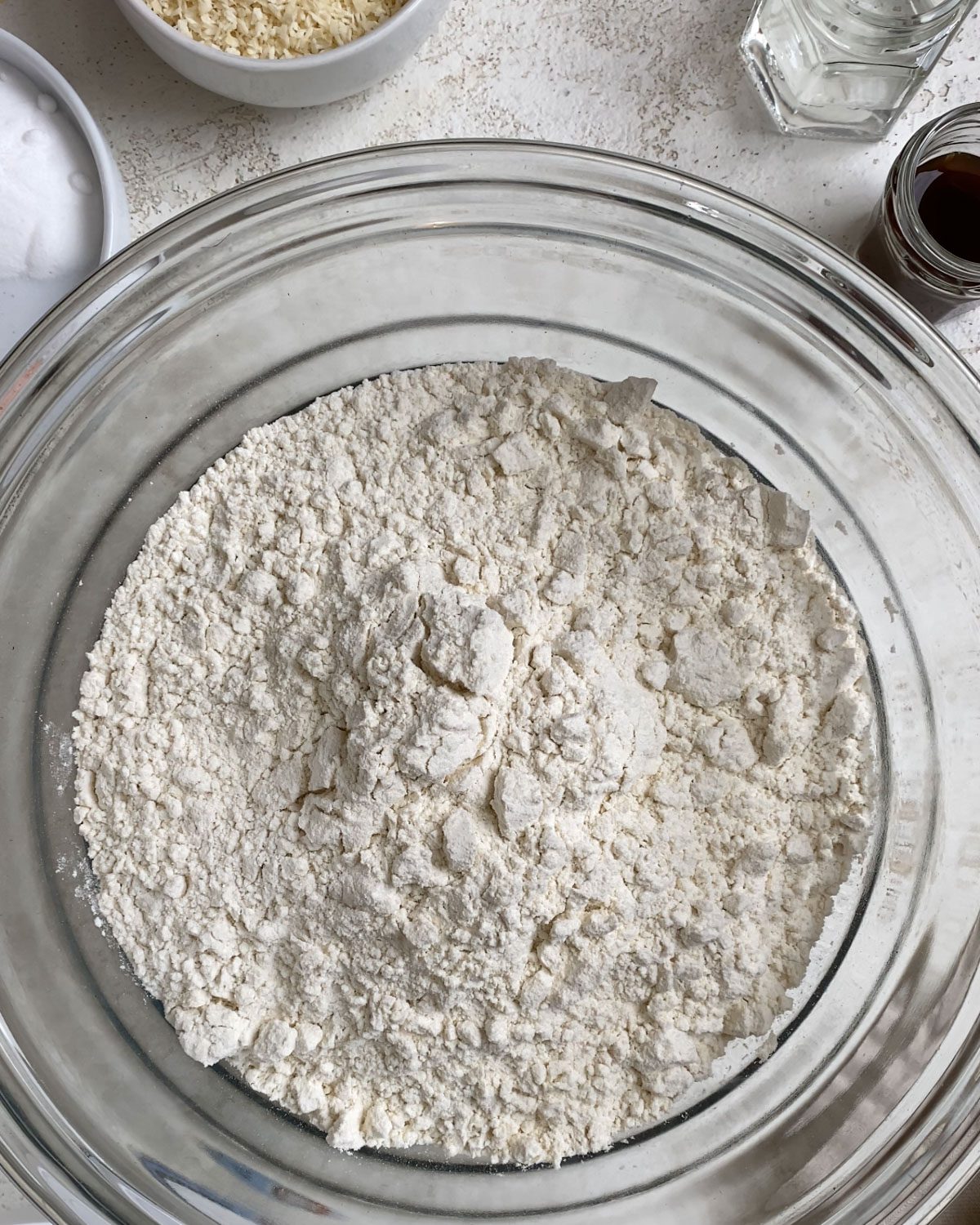 process shot of flour added to glass bowl