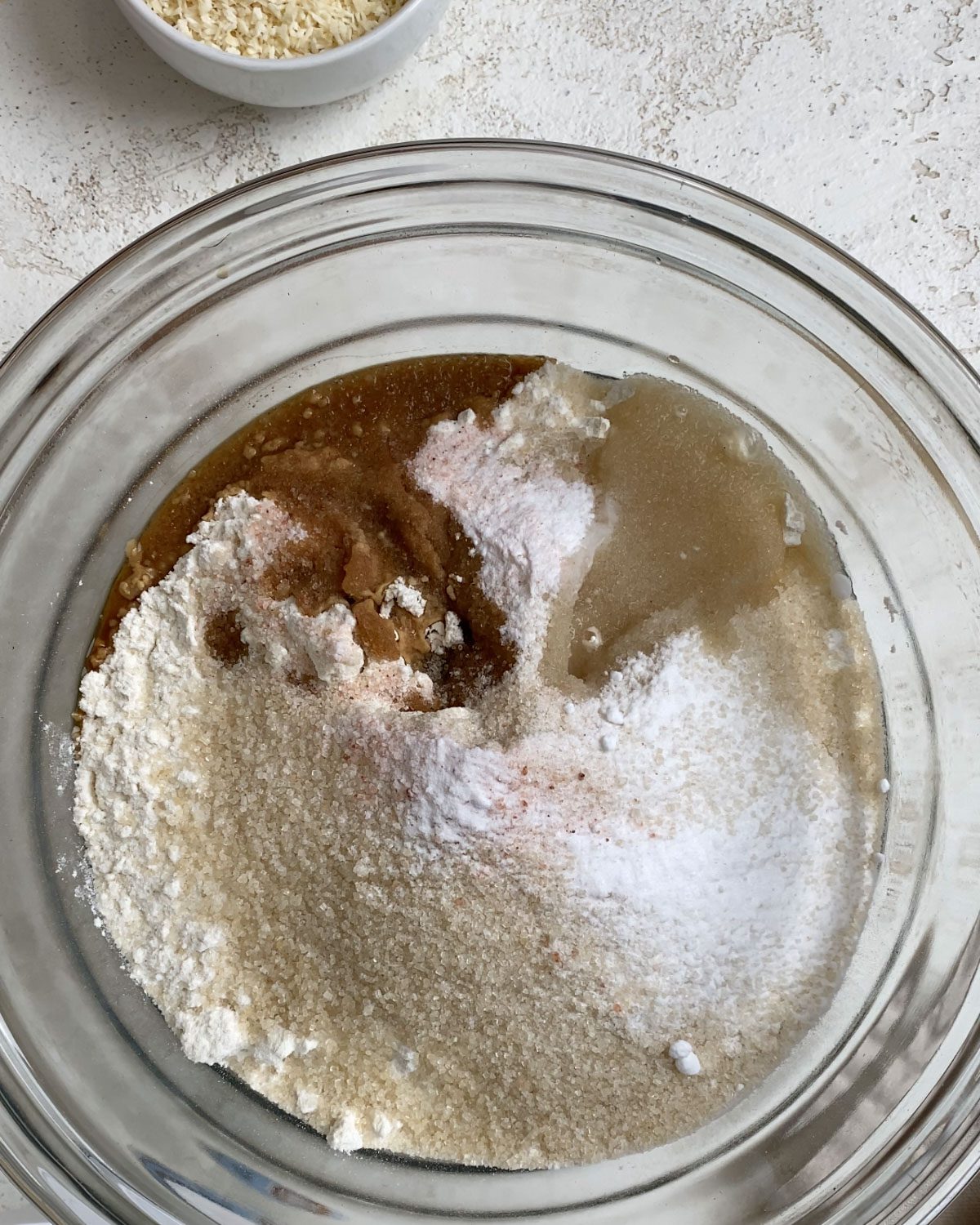 process shot of coconut extract added to glass bowl