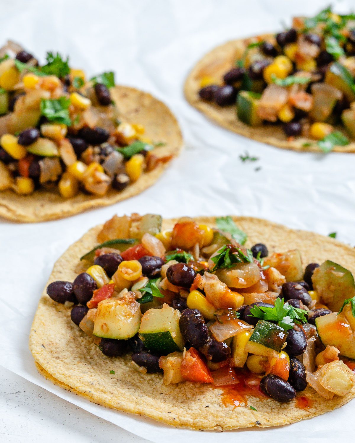 completed Vegan Black Bean Tacos with Veggies against a white surface