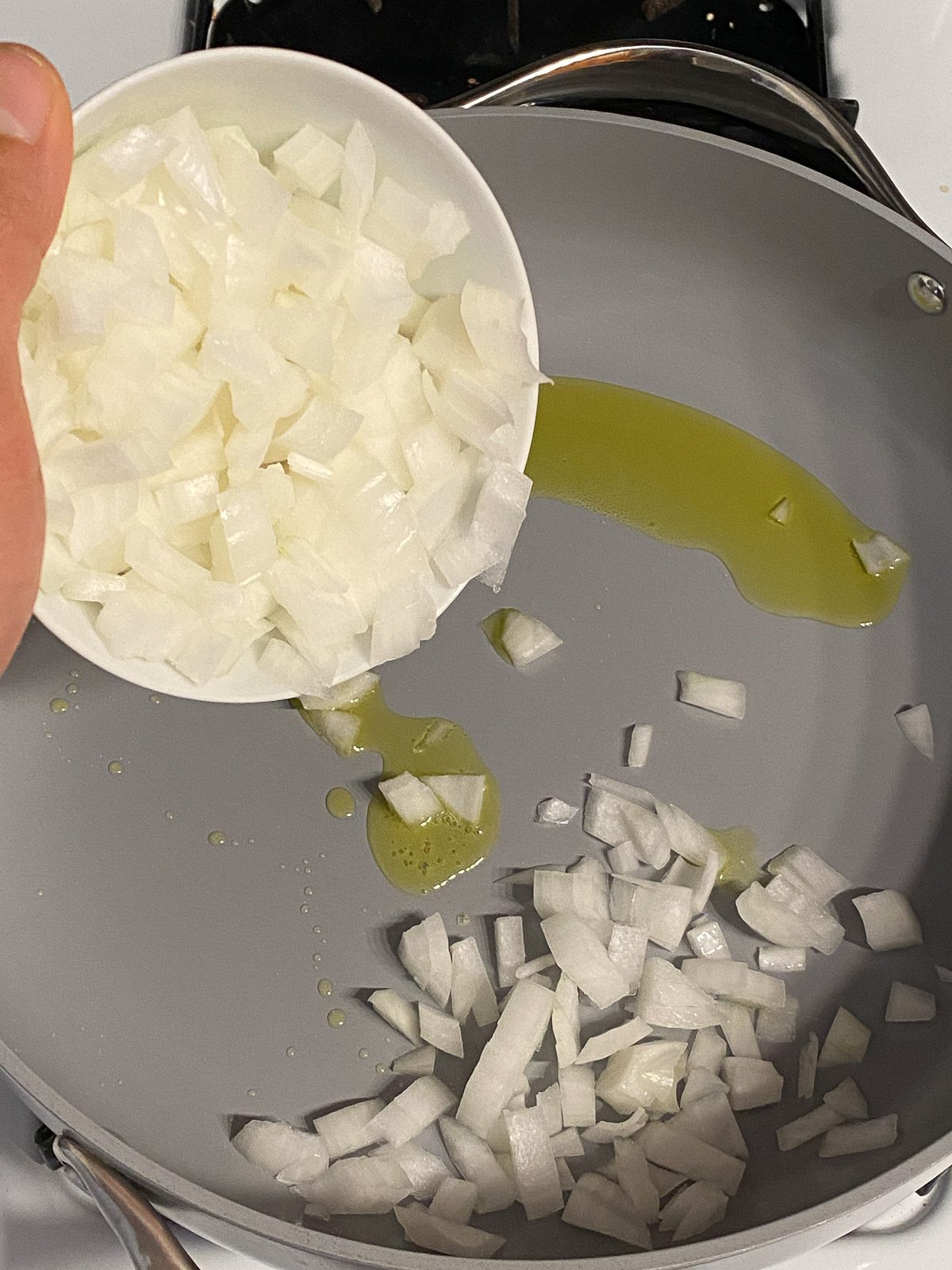 process shot of adding onions to pan