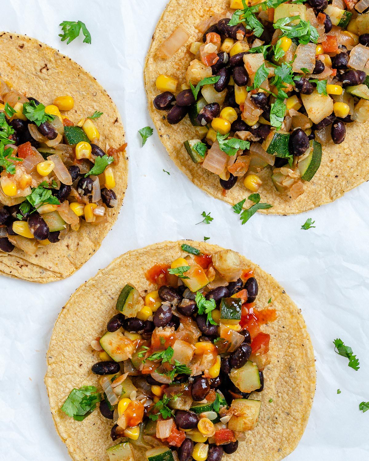 completed Vegan Black Bean Tacos with Veggies against a white surface