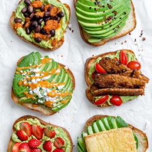 several completed pieces of avocado toast on a white surface