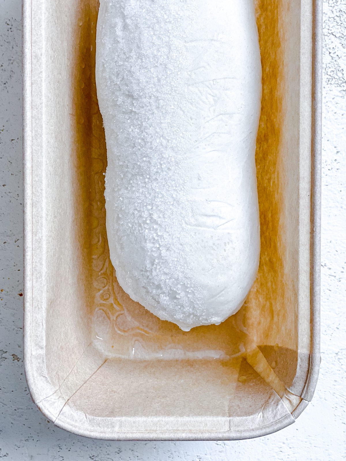 rhodes bread in bread loaf tin against a white surface