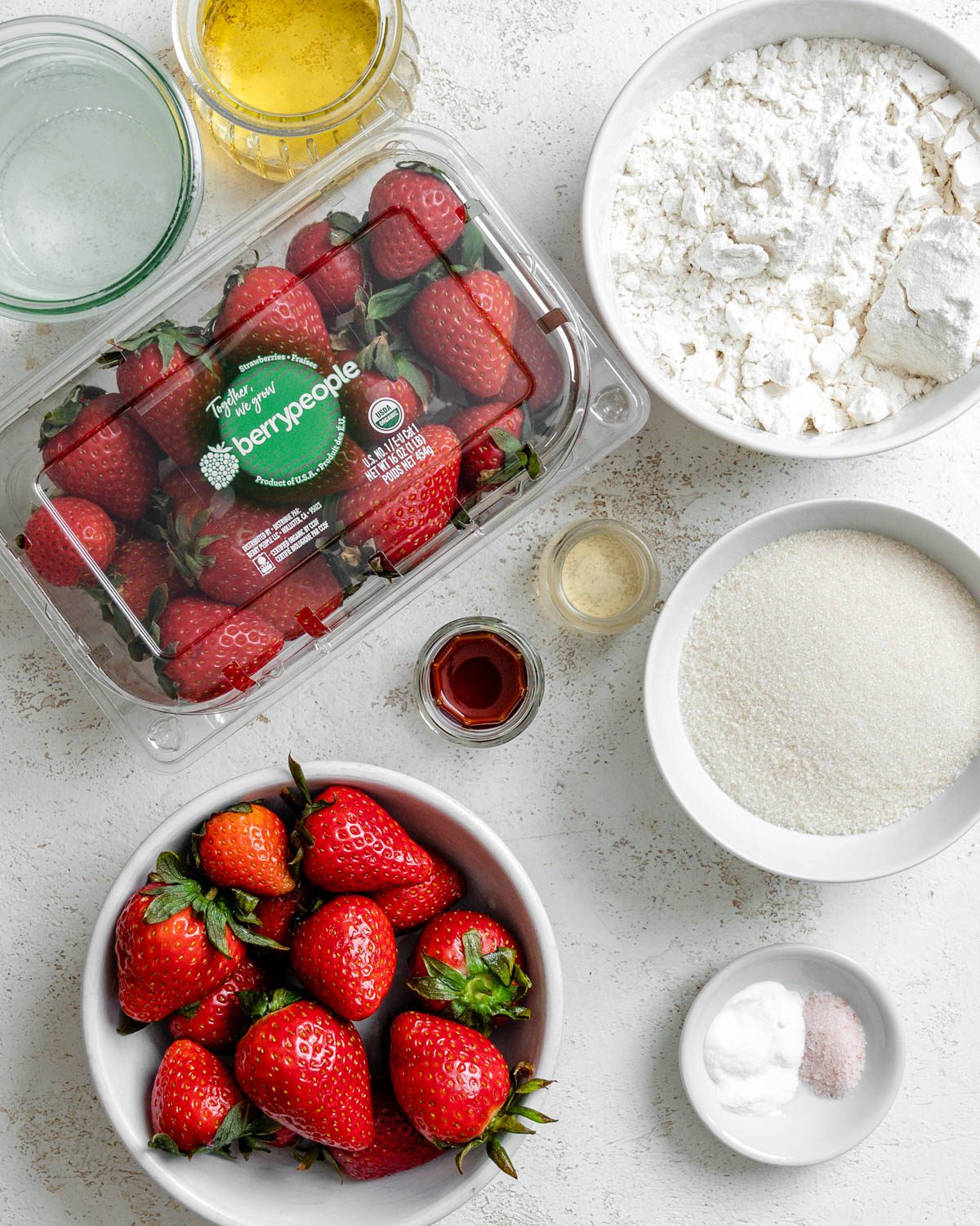 ingredients for Vegan Strawberry Cupcakes measured out against a white surface