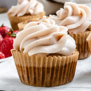 completed muffins spread out against a white surface