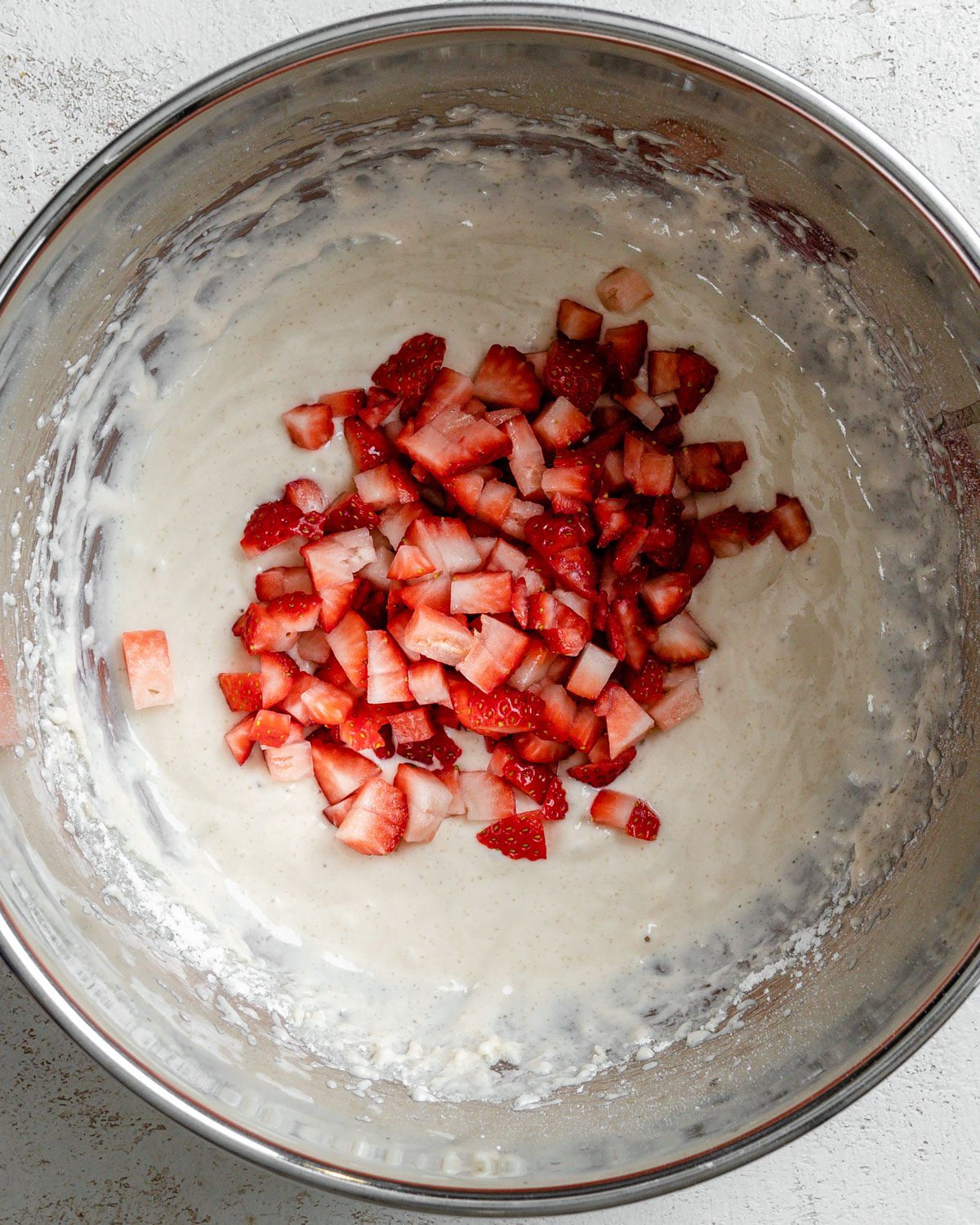 process shot of adding strawberries to batter mixture