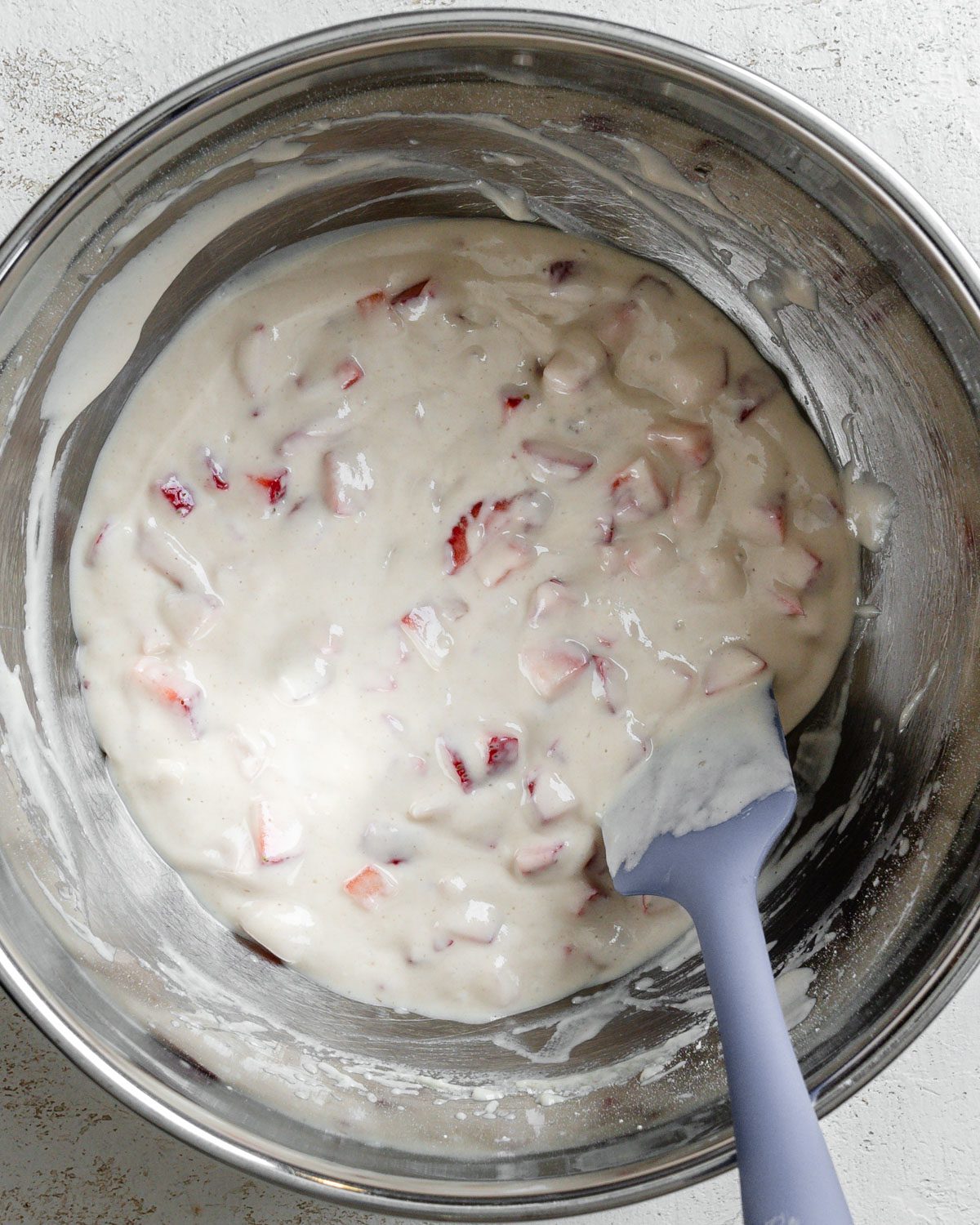 process shot post mixing strawberries into batter mixture