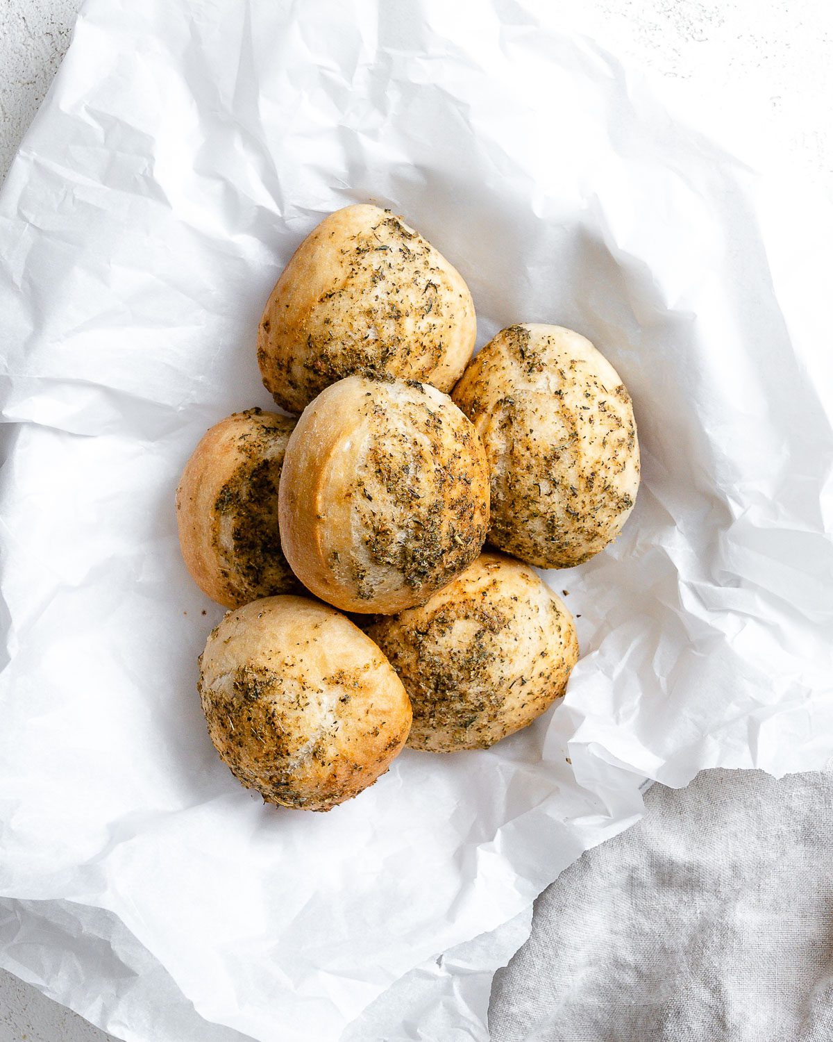 completed dinner rolls against a light background