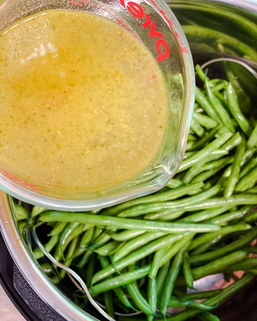 process shot of adding veggie broth to instant pot