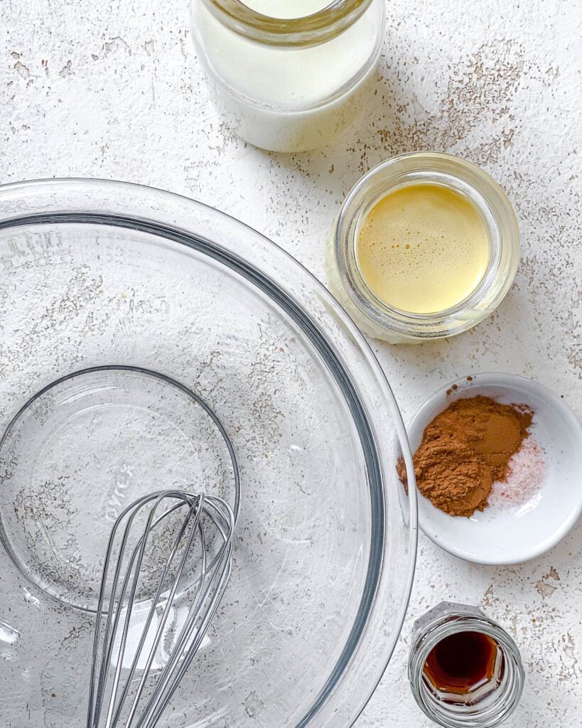 ingredients for Easy Vegan Just Egg French Toast measured out against a white surface alongside a glass bowl