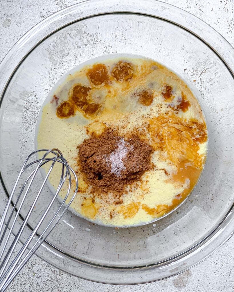 process of adding ingredients to glass bowl with whisk