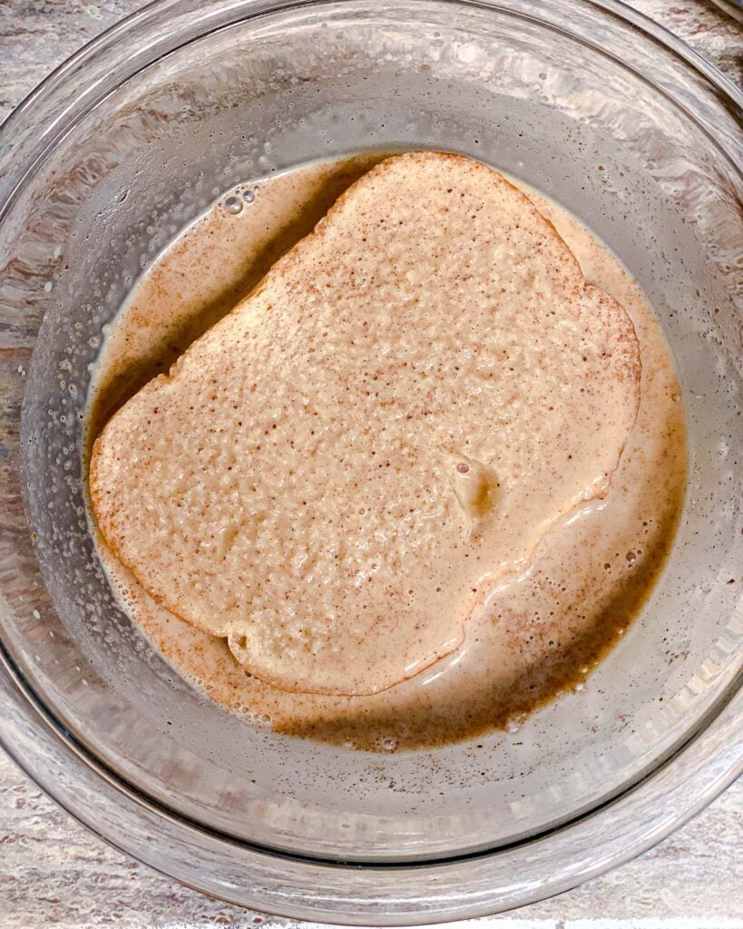 process shot of soaking other side of bread in french toast mixture
