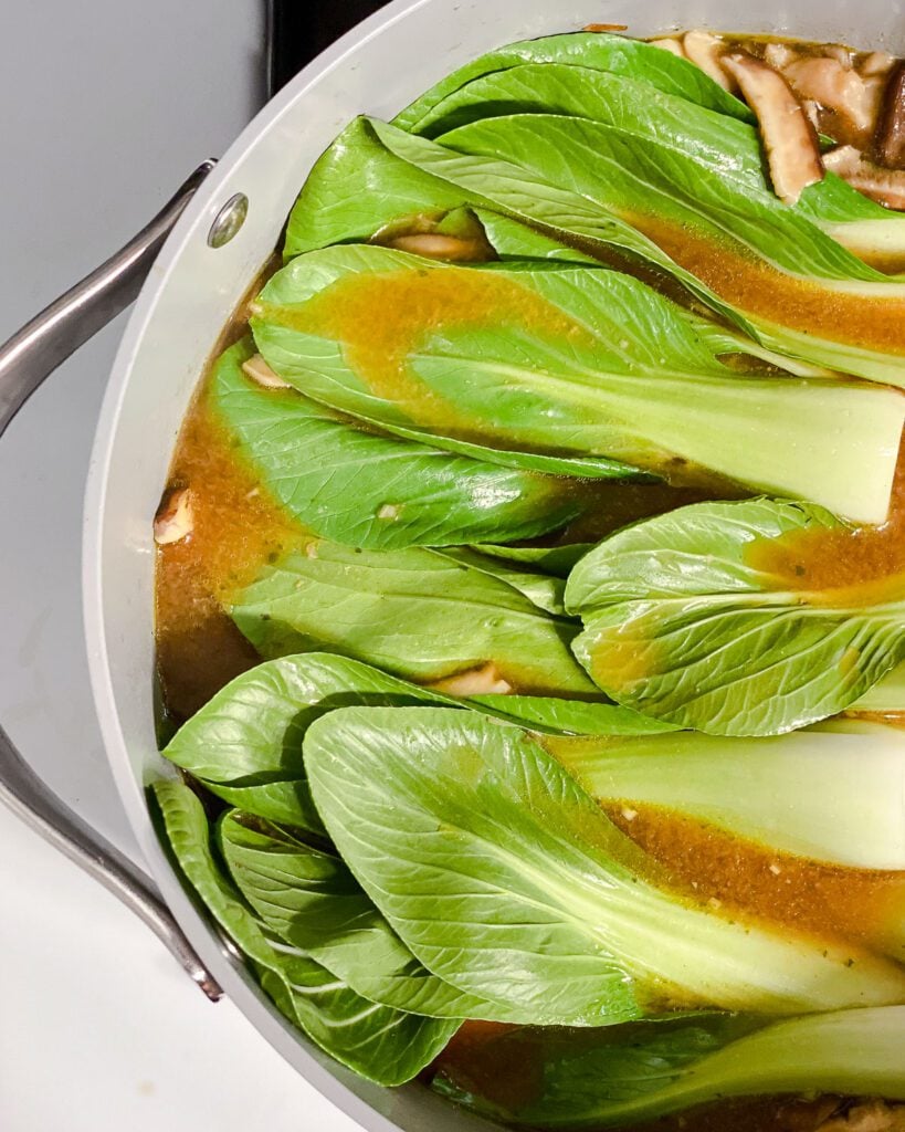 process shot of adding boy choy to pan
