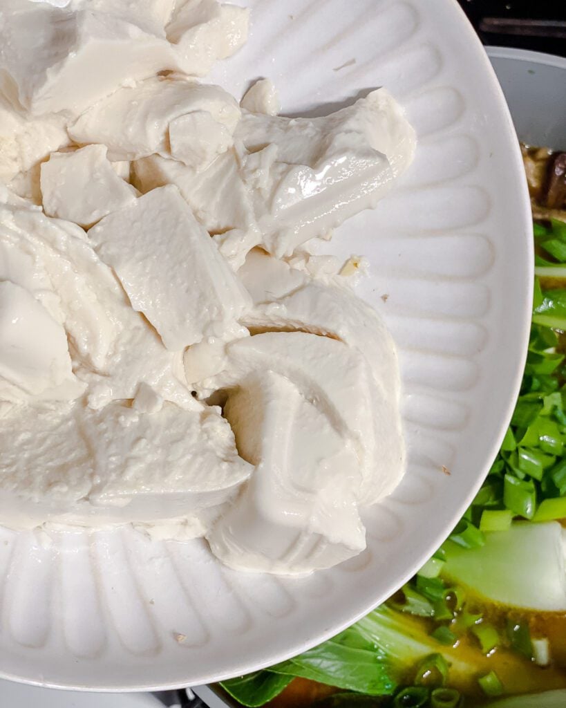 process shot of adding silken tofu to pan