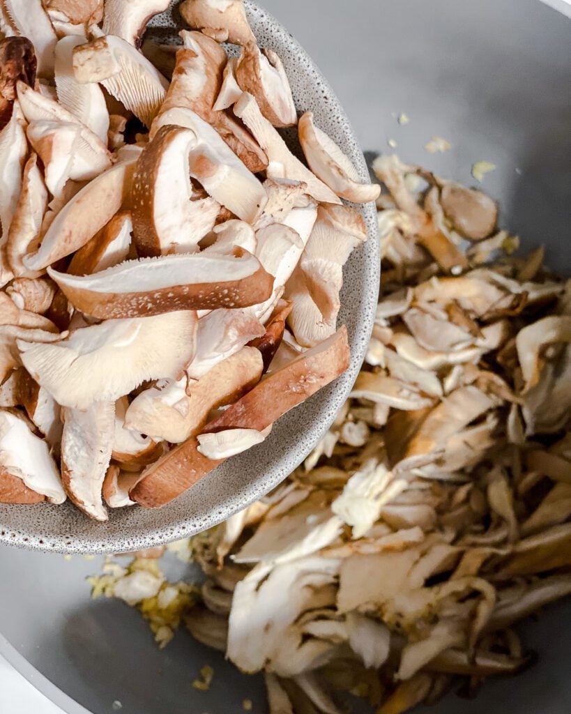process shot of adding mushroom to pan