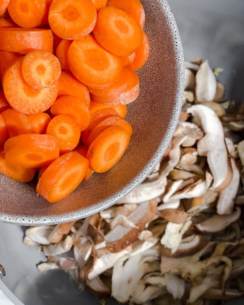 process shot of adding carrots to pan
