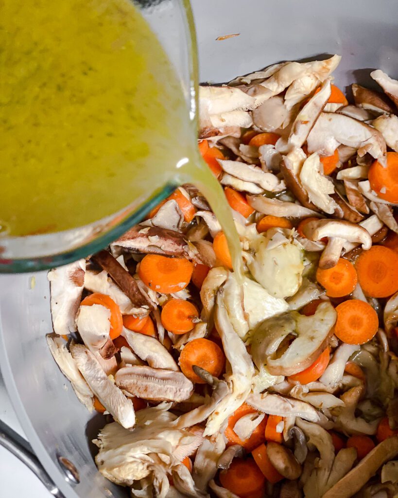 process shot of adding broth to pan
