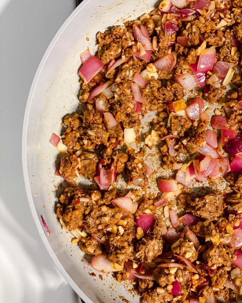 process shot of mixing in vegan chorizo to pan