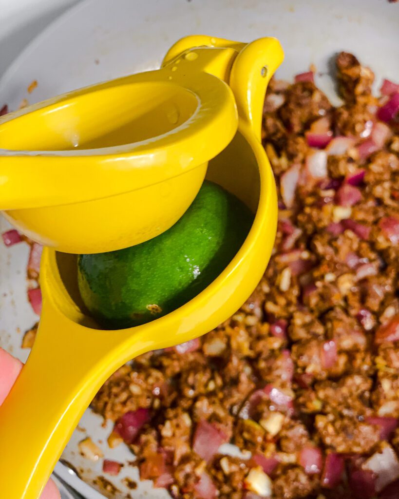 process shot of juicing one lime onto pan