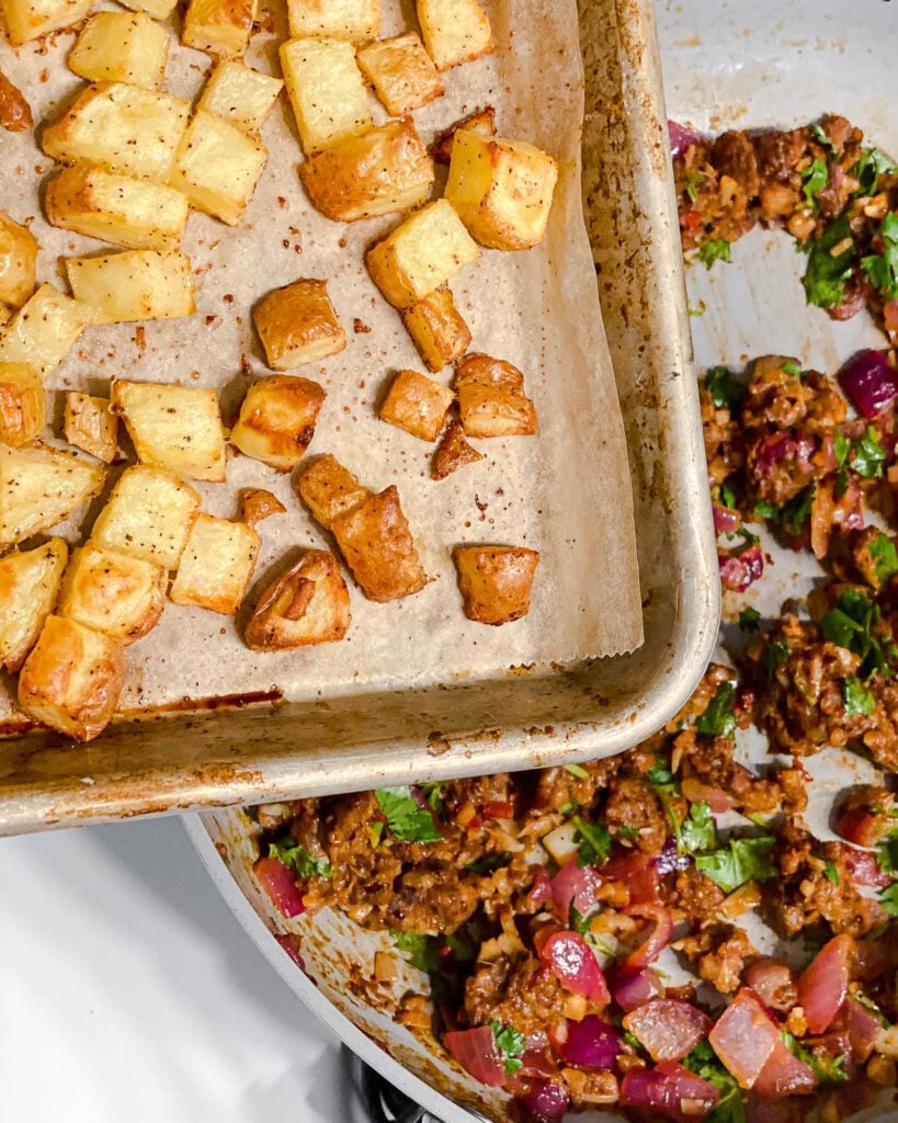 process shot of adding potatoes to pan