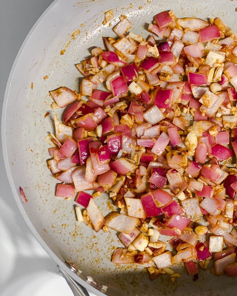 process shot of mixing ingredients together in pan