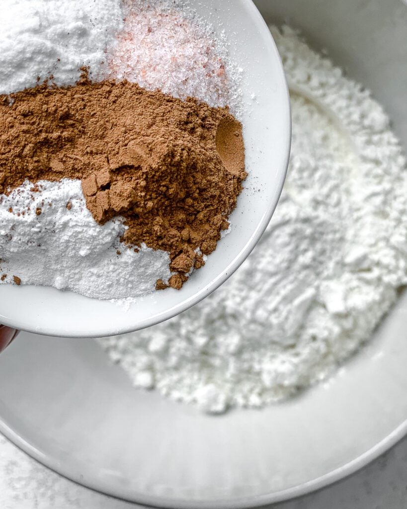 process shot of adding dry ingredients together in a bowl