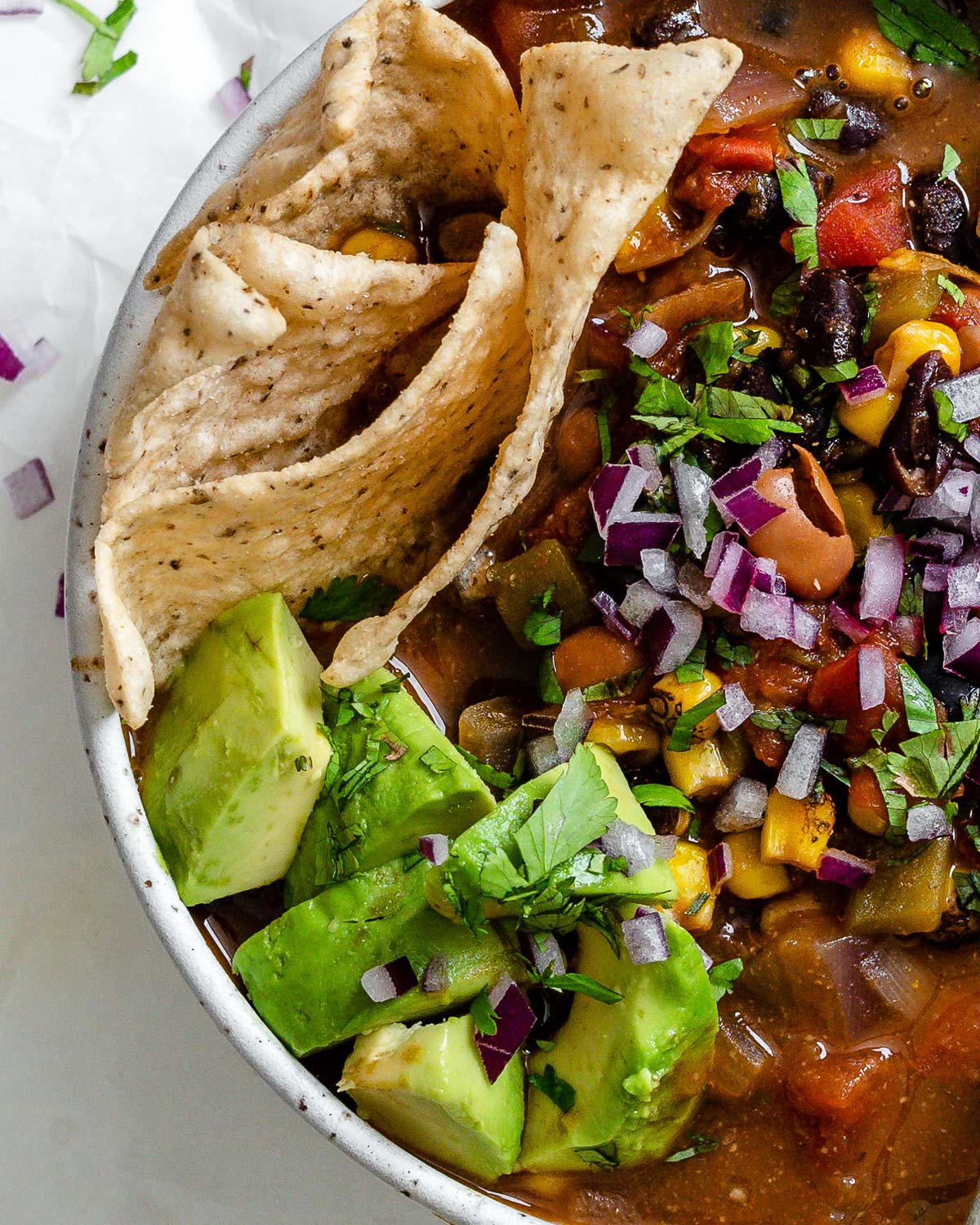 completed Easy Vegan Taco Soup in a bowl against a light surface
