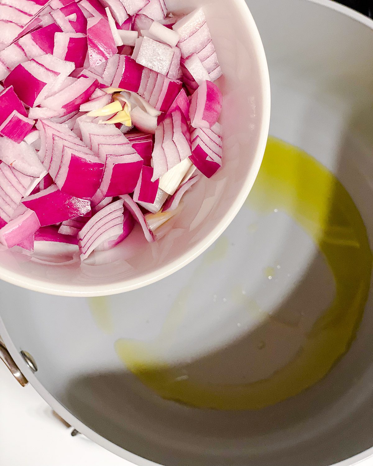 process shot of adding onions to pan