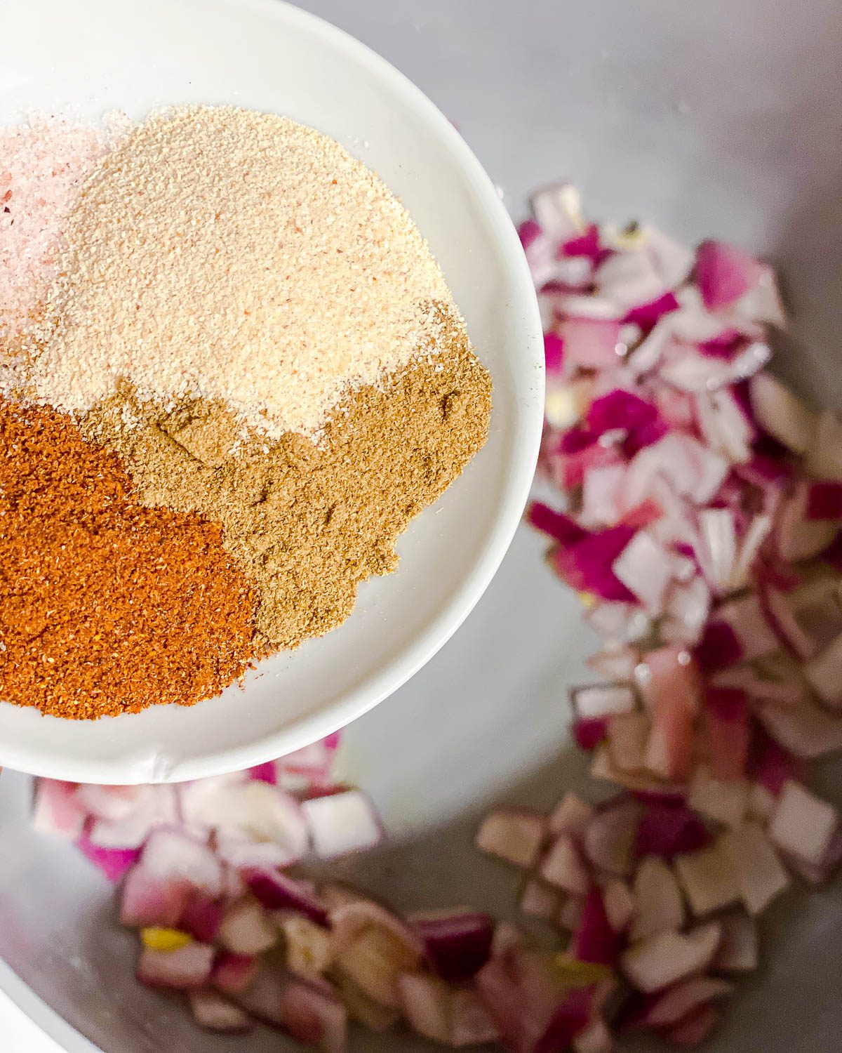 process shot of adding seasonings to pan