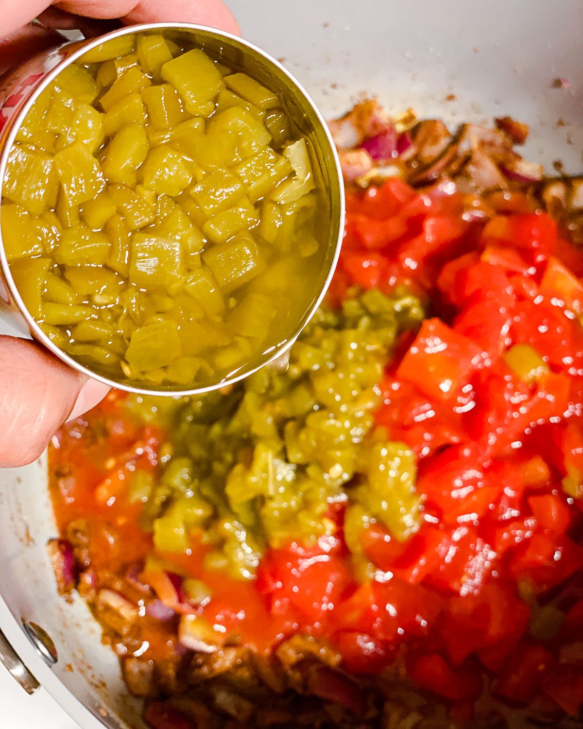 process shot of adding green chiles to pan
