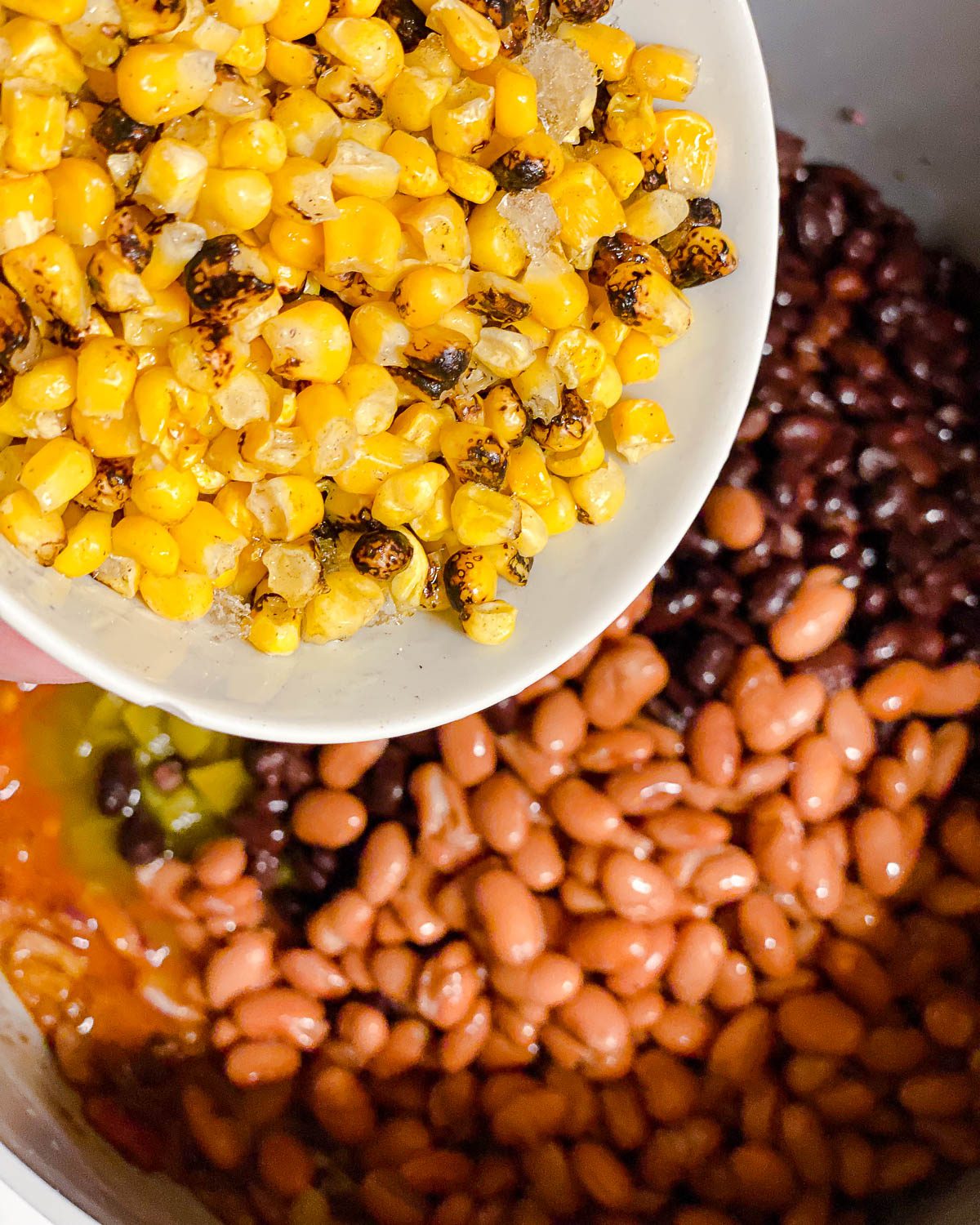 process shot of adding corn to pan