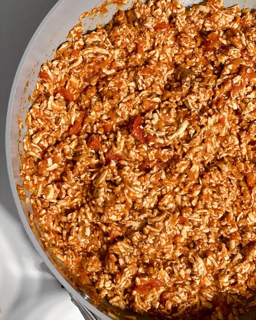 process shot of mixing ingredients together in pan