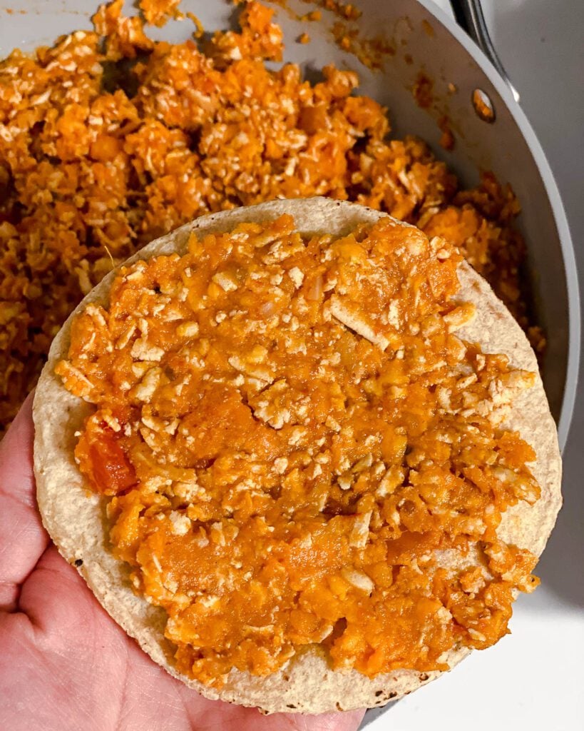 process shot of adding filling to tortilla