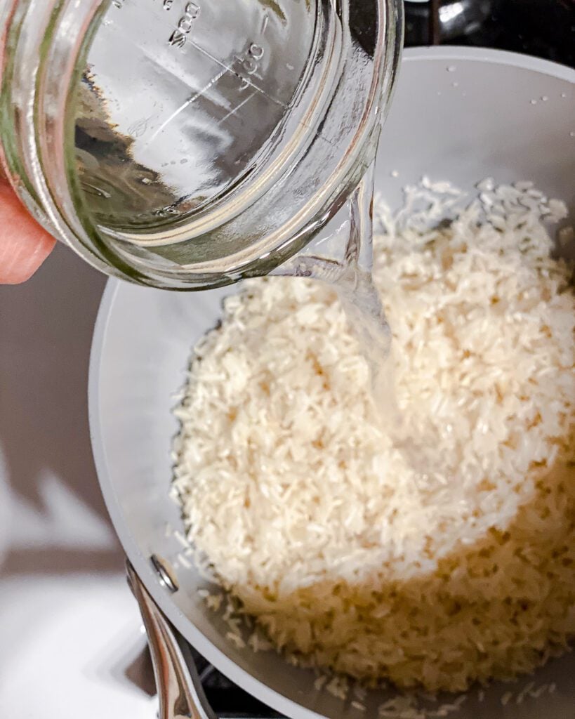 process shot of adding water to pot of rice