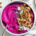 completed Dragon Fruit Smoothie Bowl (Pitaya Bowl) in a bowl against a light surface
