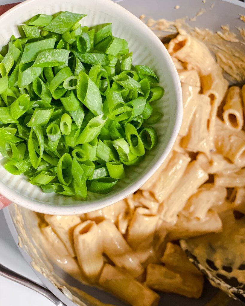 process shot of adding green onions to pan