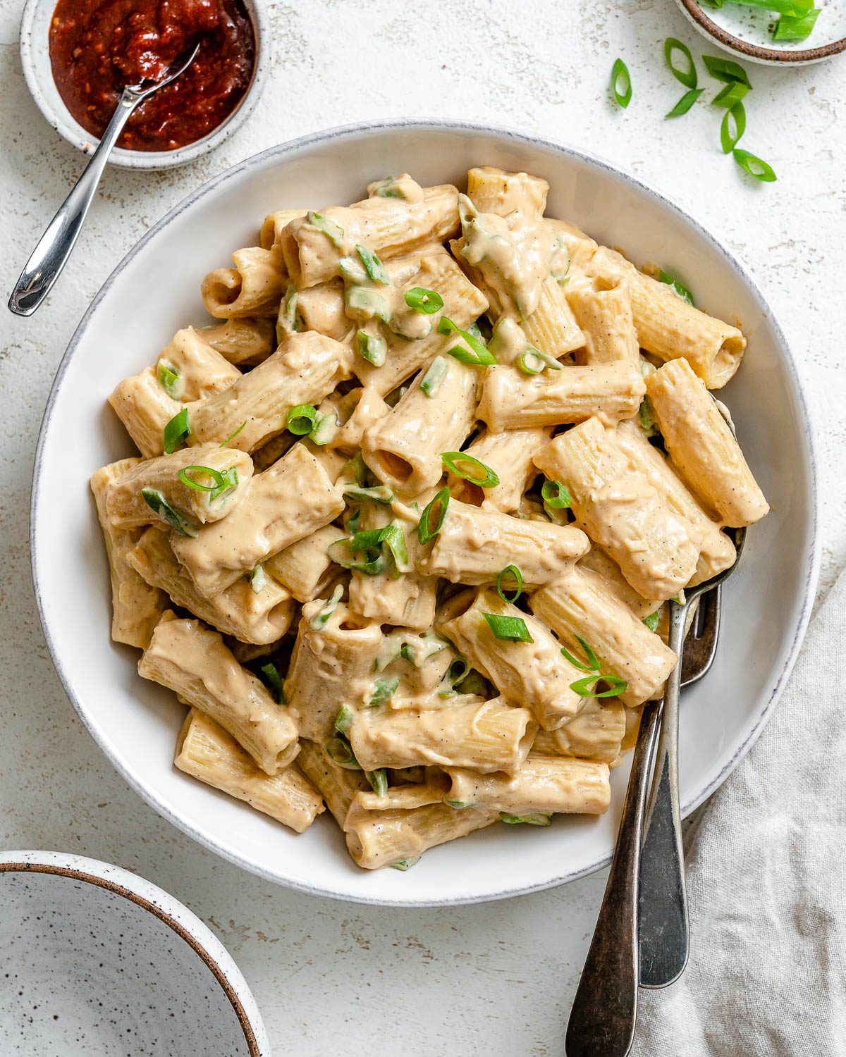 completed Creamy Gochujang Pasta plated in a white plate against a white background