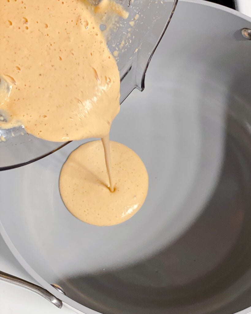 process shot of adding sauce to pan
