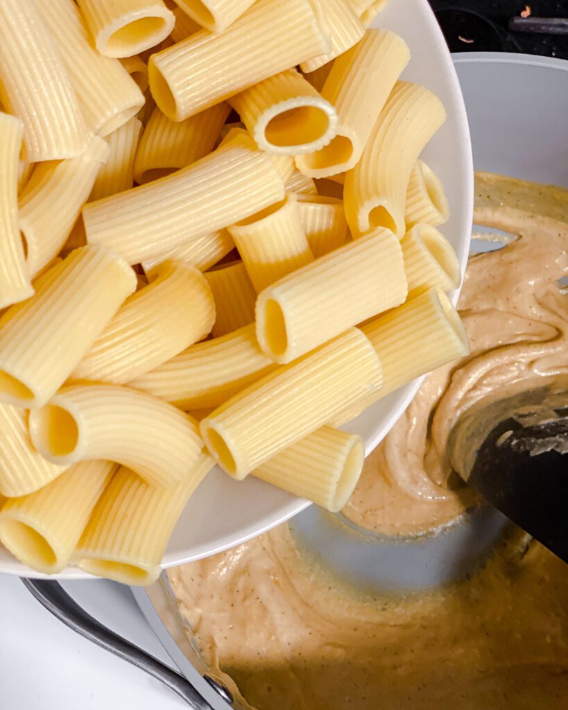 process shot of adding pasta to pan