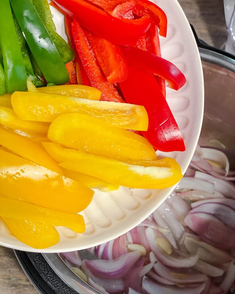 process shot of adding bell peppers to pot