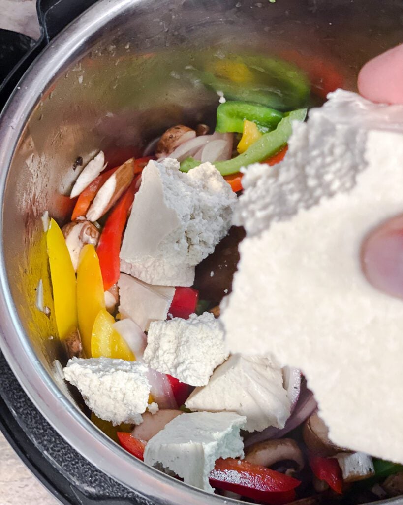process shot of adding tofu to pot