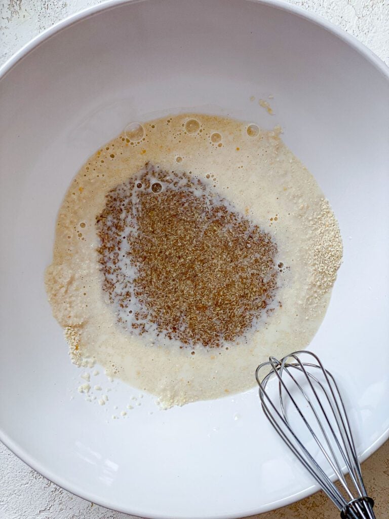 process shot of mixing breadcrumb mixture in bowl with whisk