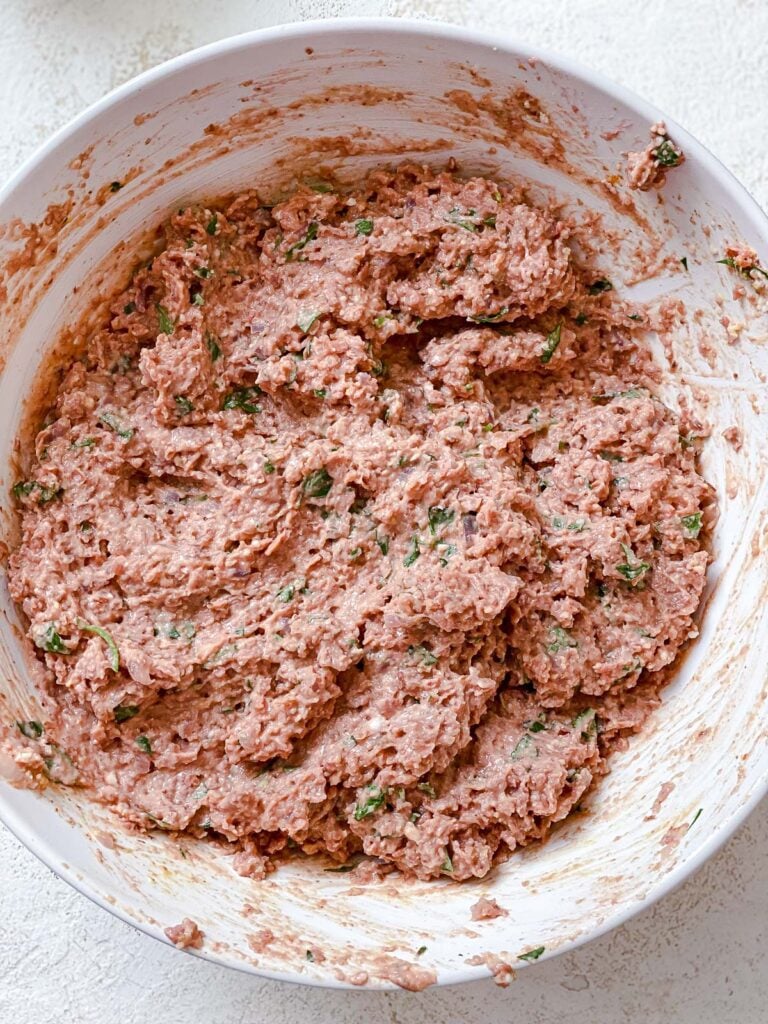process shot of mixing ingredients together in a bowl