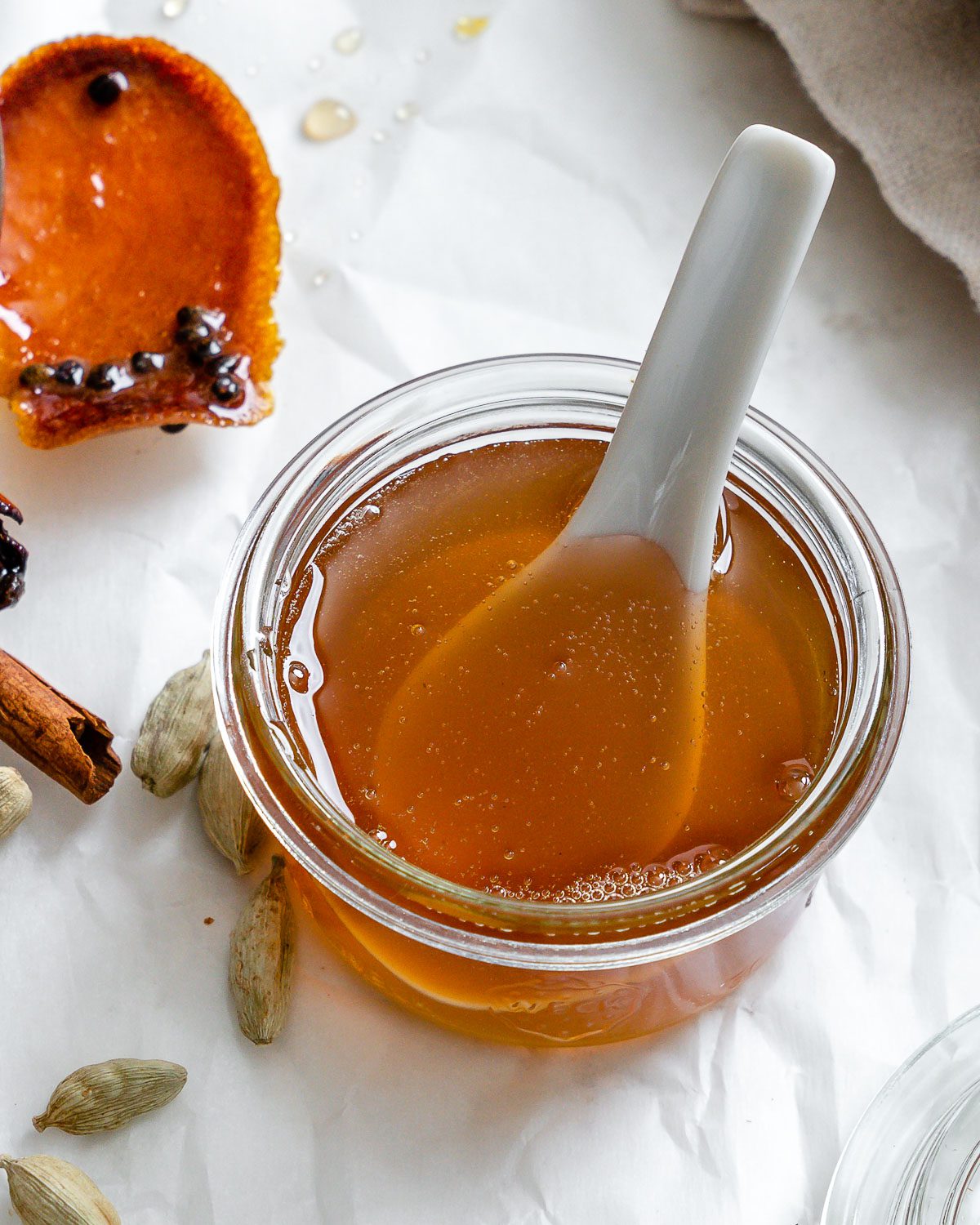 completed Cardamom Syrup in a jar with ingredients in the background